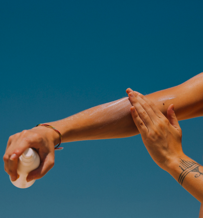 Woman applying sun cream to her arm